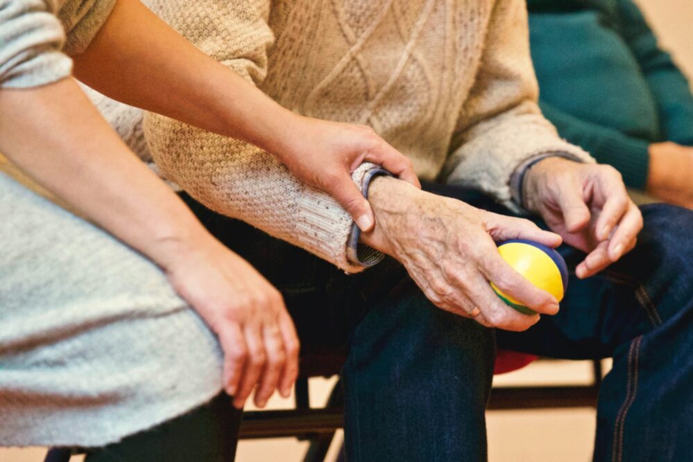elderly hand holding ball